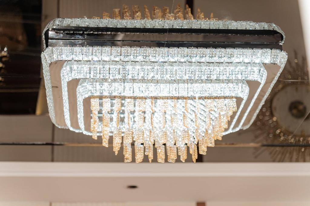 a chandelier with crystals hanging from it at Sea View Apartment Muong Thanh Oceanus Nha Trang in Nha Trang