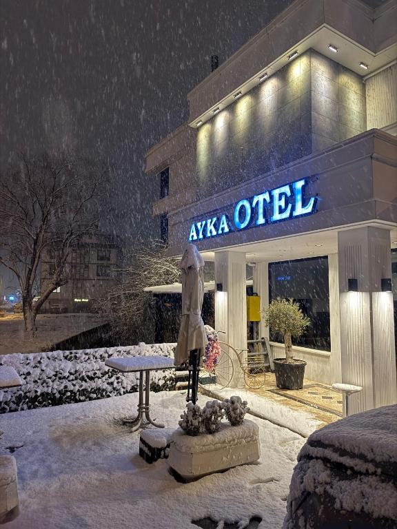 a building with a statue outside in the snow at ATAKAUM AYKA OTEl in Atakum