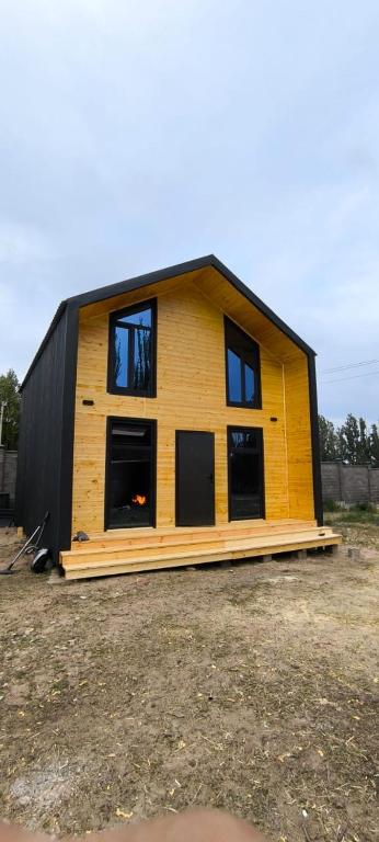 a house that is being built in a field at Adam in Chon-Sary-Oy