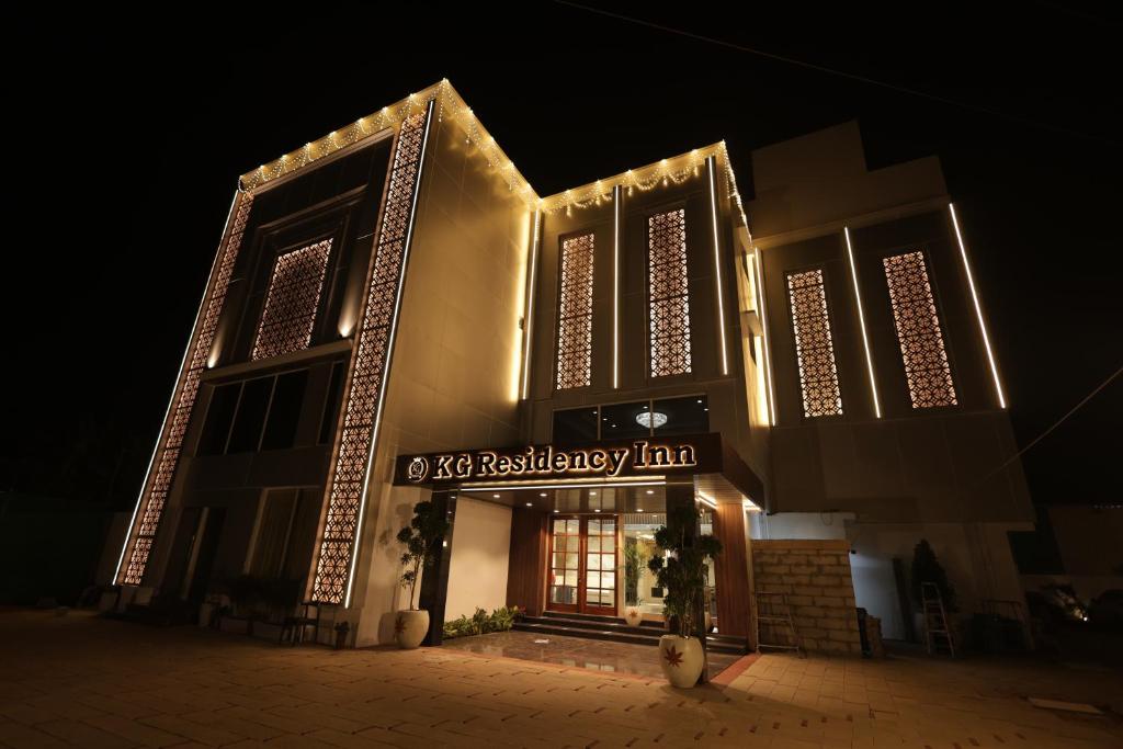 a building with a sign on it at night at KG Residency Inn in Thanjāvūr