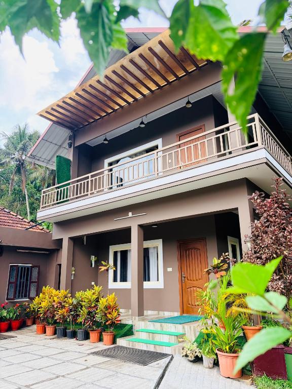 a house with plants in front of it at Linn View Home Stay Munnar in Munnar
