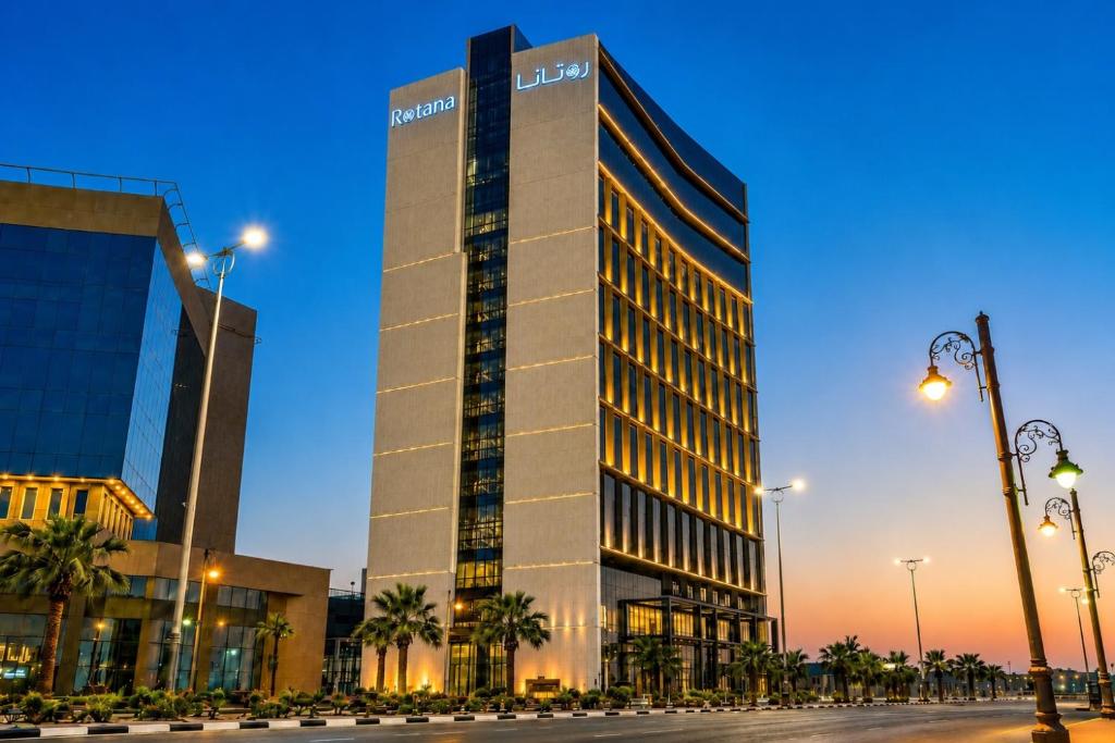 a tall building with a sign on the side of it at Rotana Corniche in Dammam
