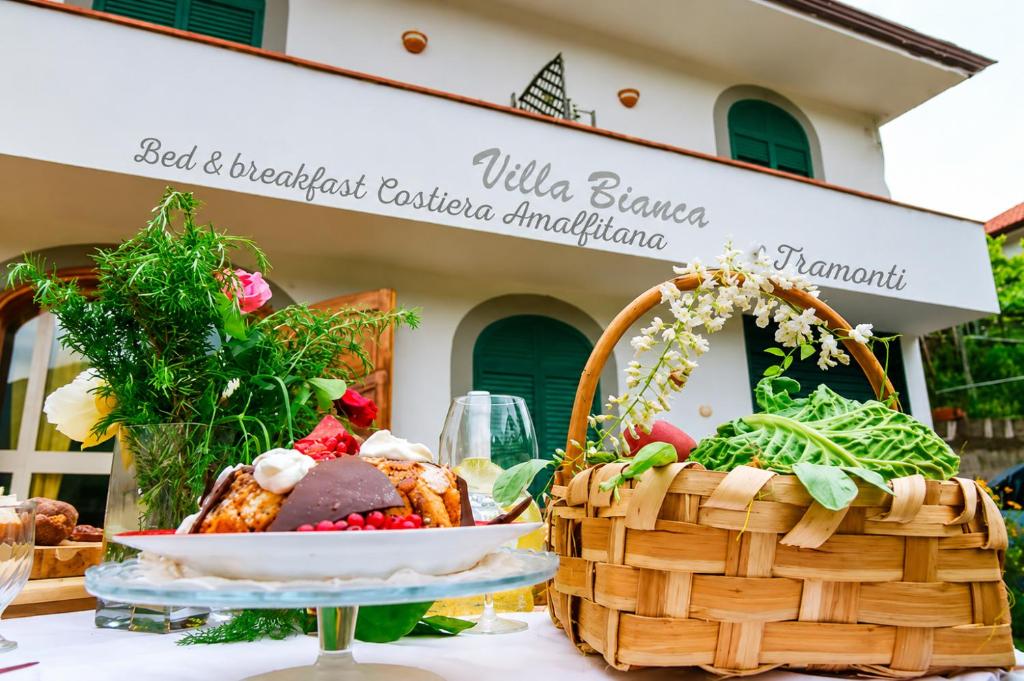 a table with a basket of food and a plate of food at Villa Bianca in Tramonti