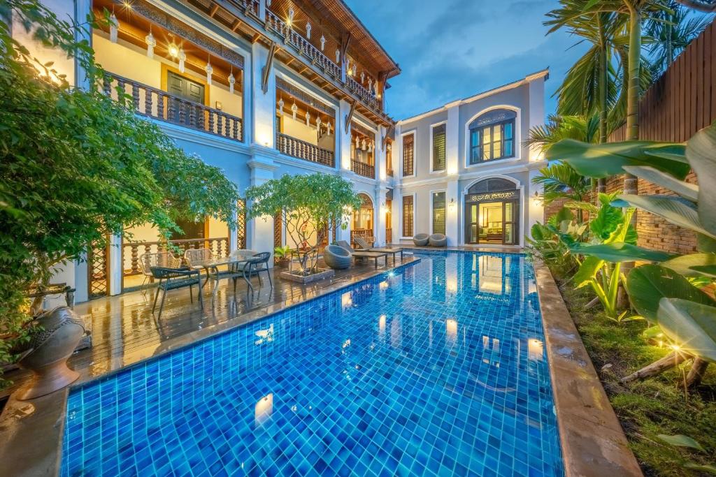 an exterior view of a swimming pool in a villa at At Tree Hotel Thaphae Gate Chiangmai in Chiang Mai