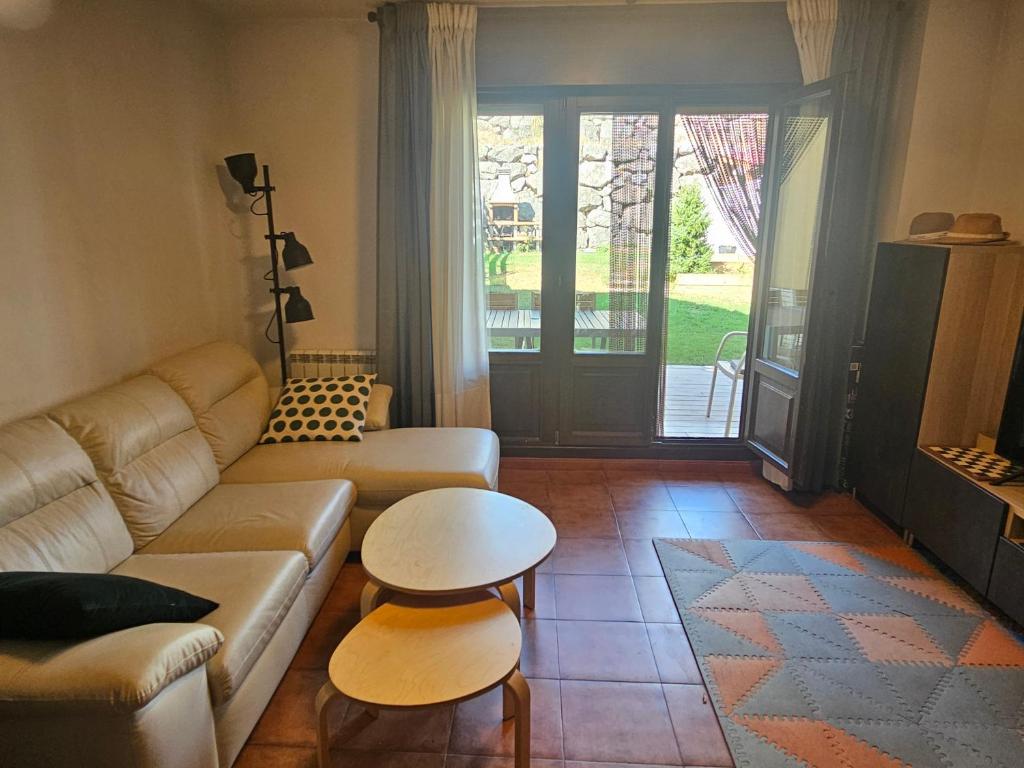a living room with a couch and a table at Villa Sojuela Green in Sojuela