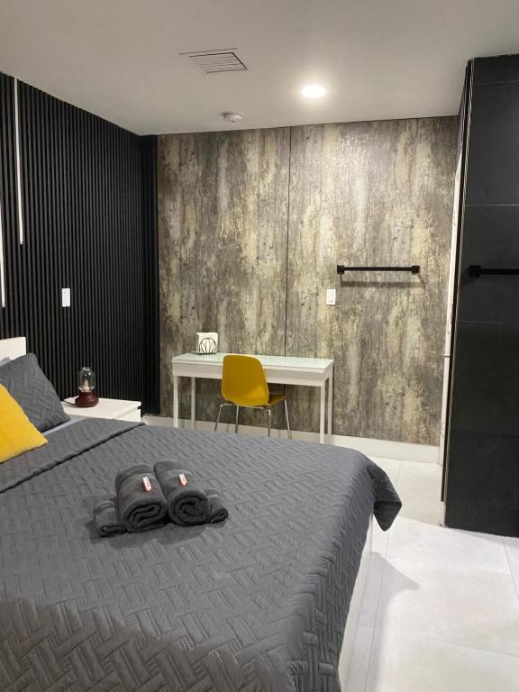 a bedroom with a bed with a table and a yellow chair at Private Room-1 in Miami
