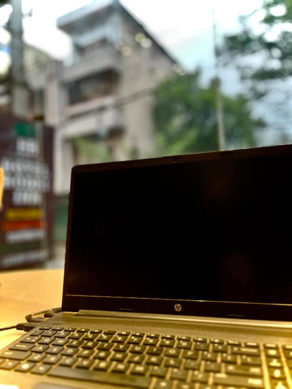 a laptop computer sitting on top of a wooden table at Bodhi international in Gaya