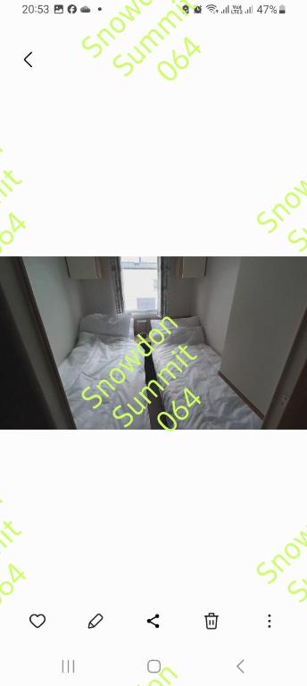 a bed in a room with a sign that says sell at Snowdon summit 064 in Barmouth