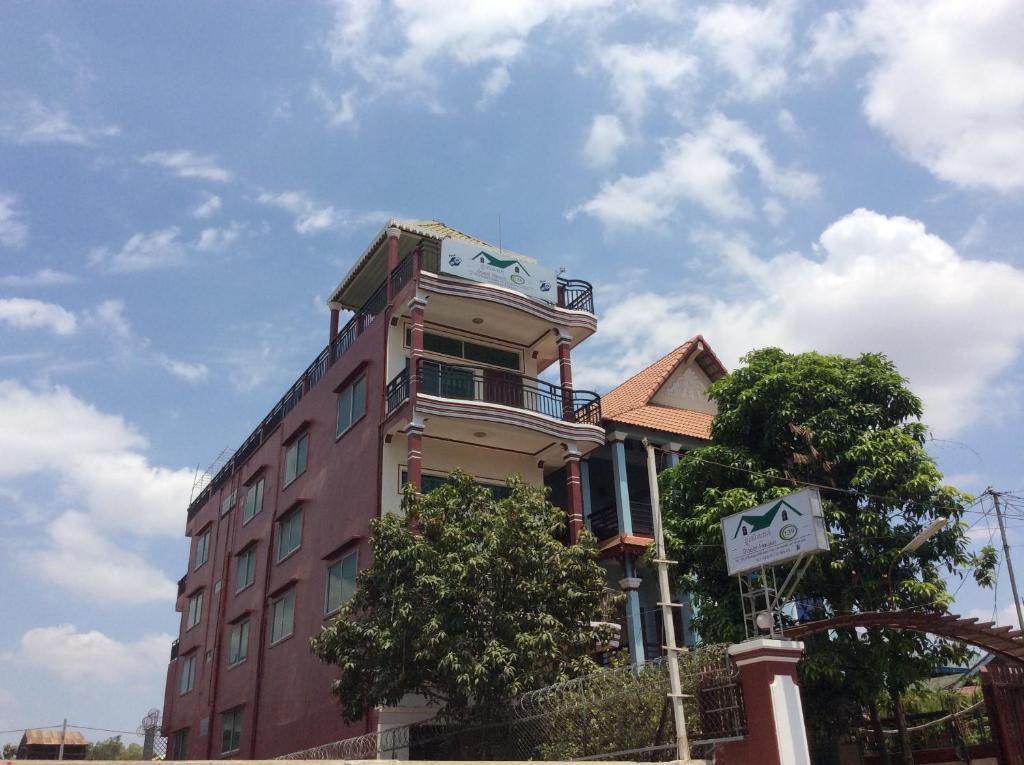 a tall building with a balcony on top of it at 139 Guest House in Phnom Penh