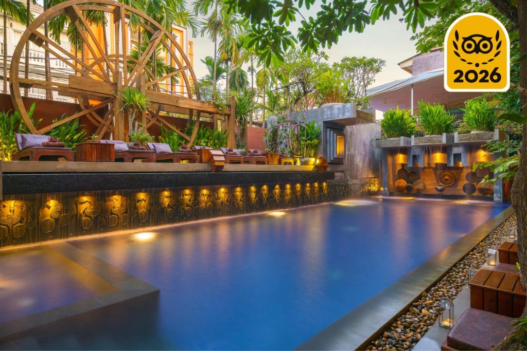 a swimming pool at a resort with a sign that reads ko at Golden Temple Residence in Siem Reap