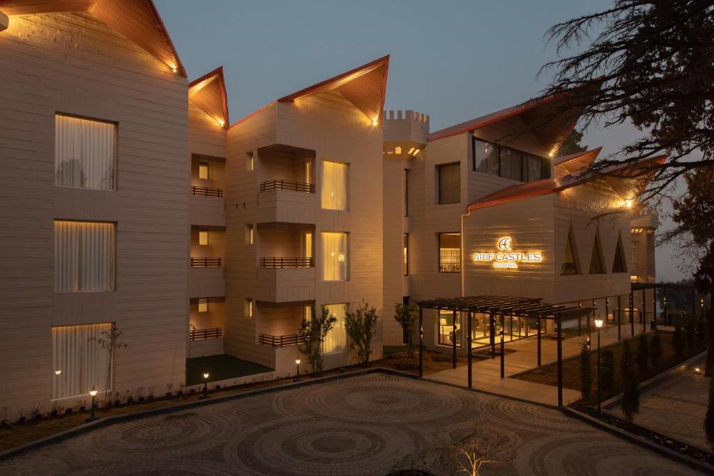 an apartment building with a courtyard at night at Hotel Arif Castle, Nainital in Nainital