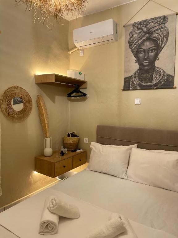 a bedroom with a bed and a picture of a woman at Boho Nest in Mytilene