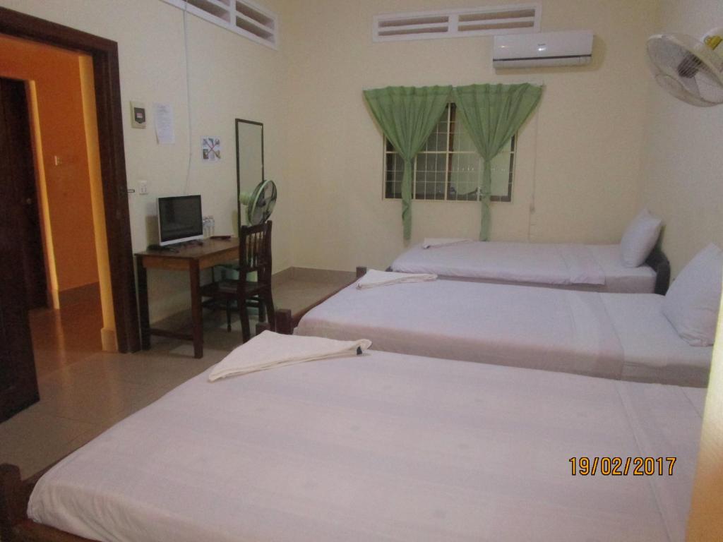 Postel nebo postele na pokoji v ubytování Visal Sak Guesthouse