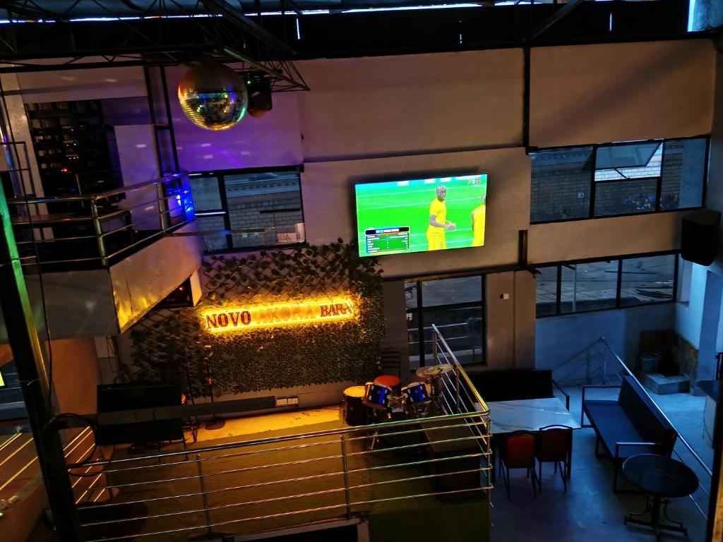 a view of a bar with a tv in a building at Novo Axora Lounge & Accommodation Kimbo Ruiru Kimbo Lopha Stage in Ruiru