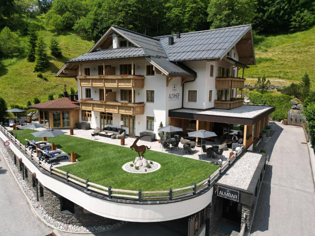 a house with a statue in front of it at ALMHOF Alpin Apartments & Spa in Dienten am Hochkönig
