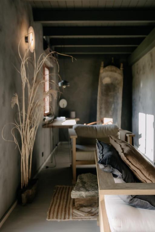 a living room with a couch and a table at Flumen MIkoszewo in Skorka