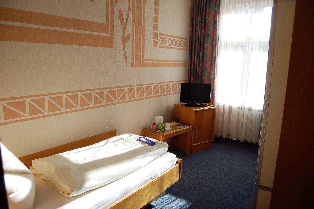 Postel nebo postele na pokoji v ubytování Hotel Graf Pückler