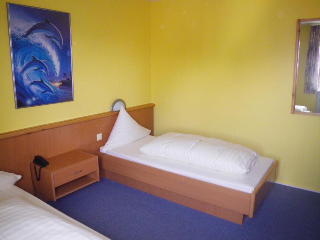 Postel nebo postele na pokoji v ubytování Hotel Stadt Baunatal