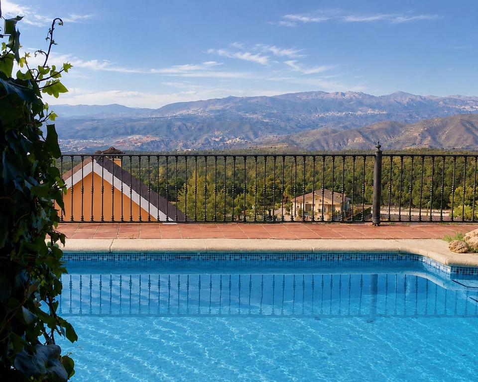 a swimming pool with a view of the mountains at Hotel El Balcon de las nieves in La Zubia