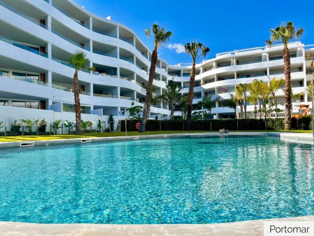 a swimming pool in front of a large apartment building at Playa Granada Mar de Fabiola in Motril