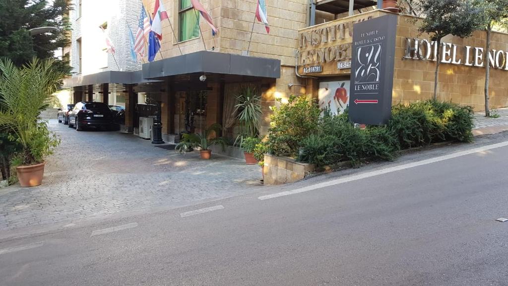 a street in front of a building with plants at hotel le noble in Beirut