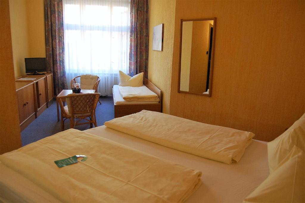 Postel nebo postele na pokoji v ubytování Hotel Graf Pückler