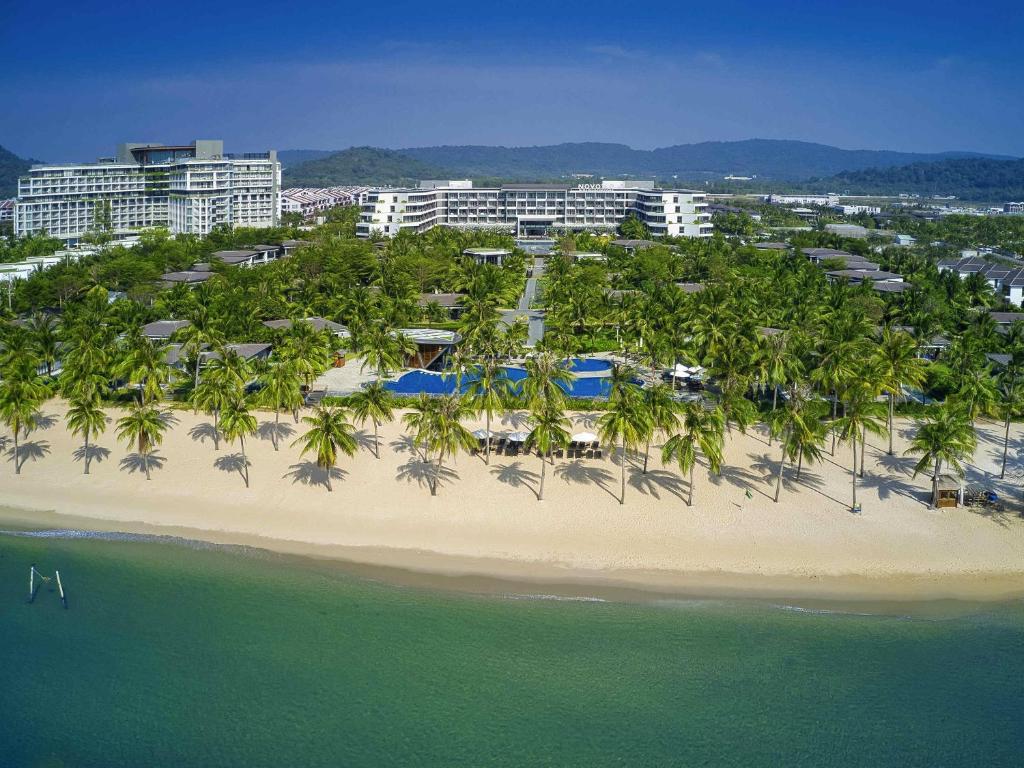 an aerial view of a resort with palm trees and the ocean at Novotel Phu Quoc Resort in Phú Quốc