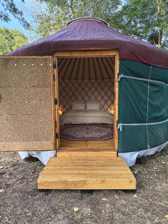 a tent with a bed inside of it at Yourte pour deux - Voie Bleue in Bayon