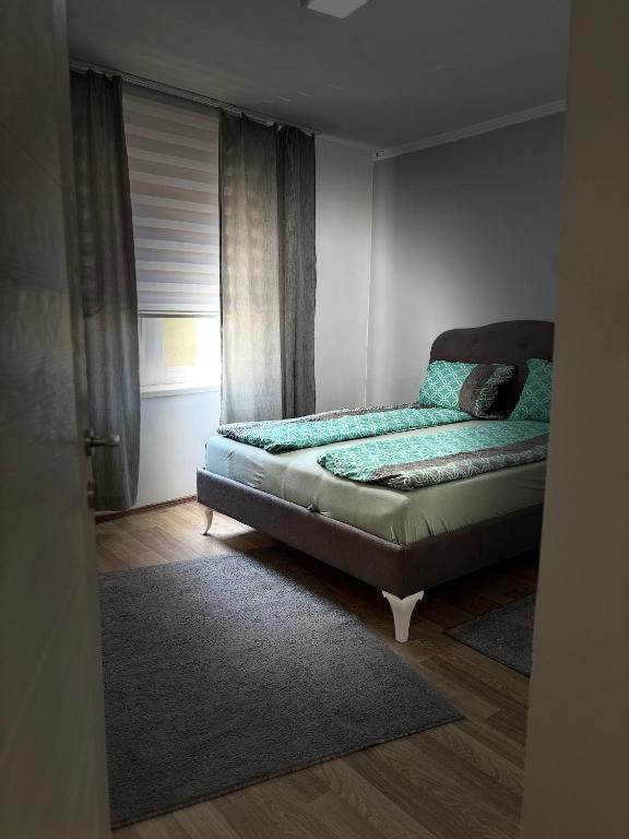 a bed in a room with a window at Deluxe apartment Amar in Sarajevo