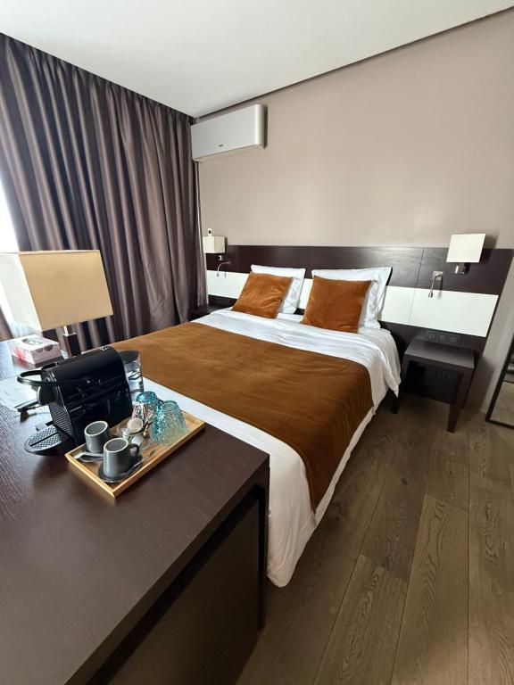 a hotel room with a large bed and a desk at Hotel SKØL in Strassen