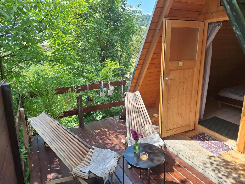 a deck with two chairs and a table at Ozy's place in Kamnik