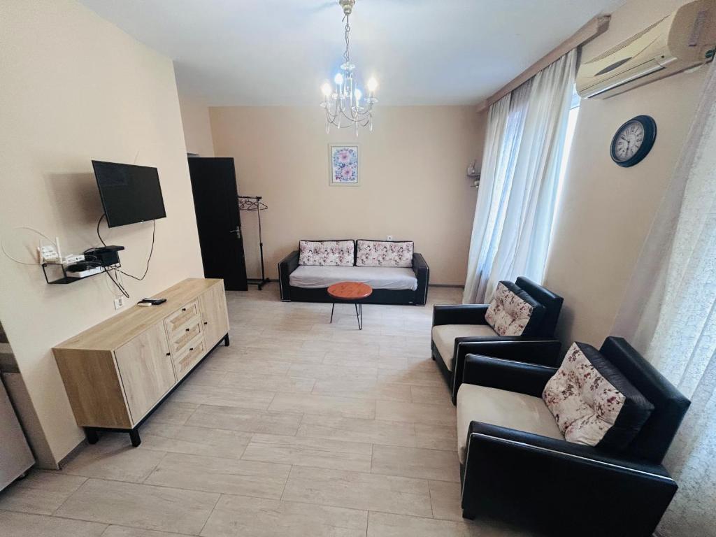 a living room with a couch and a table at Apartment near Tskaltubo spa resort in Tsqaltubo