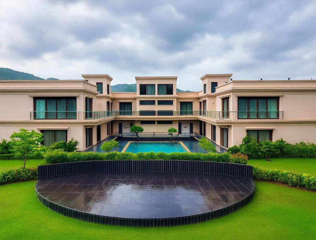 an exterior view of a large building with a pool at Estrella The Resort in Karjat
