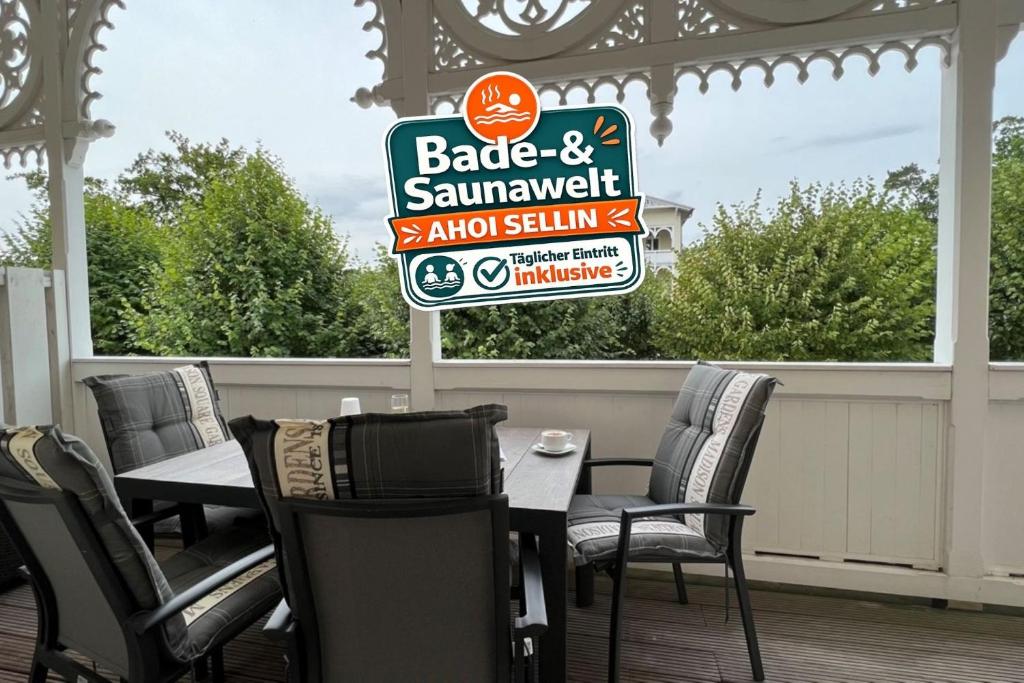 a sign for a barbecue and sampler restaurant on a porch at Villa Sonneck, App 07 - Bade- & Saunawelt täglich inklusive in Ostseebad Sellin