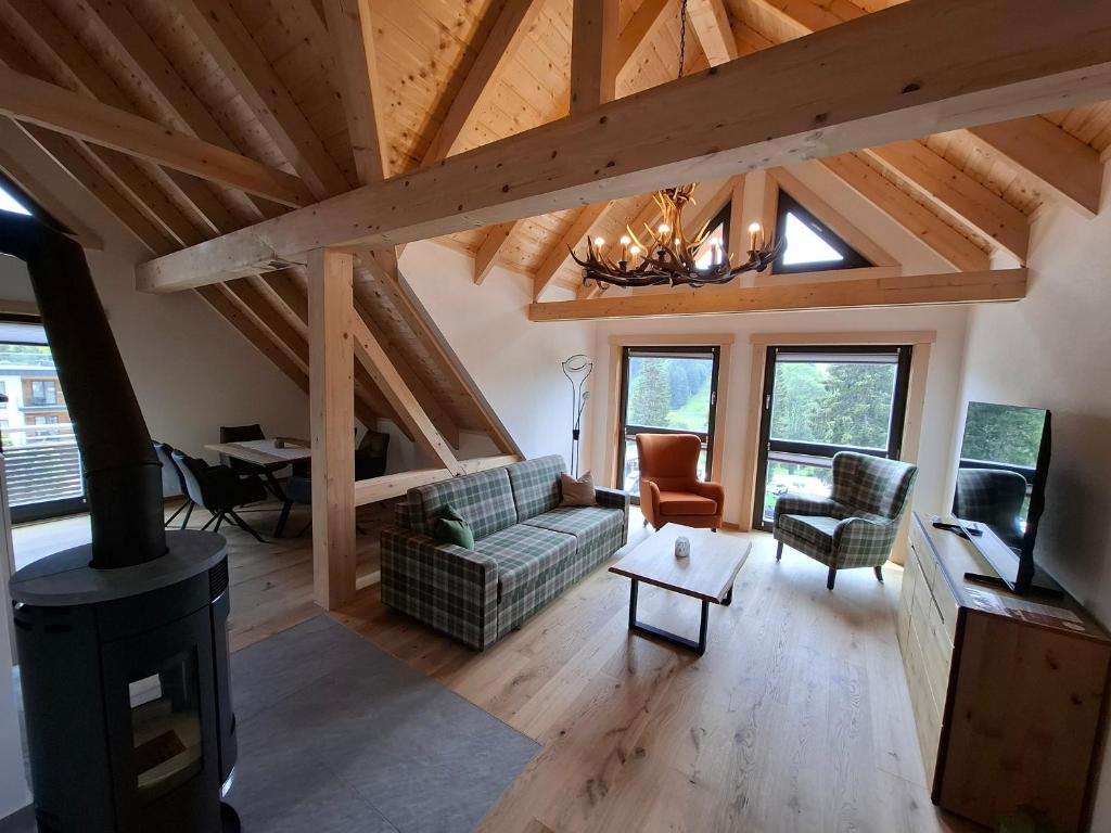 a living room with a couch and a stove at Schwarzwald Wellness Chalet in Todtnau