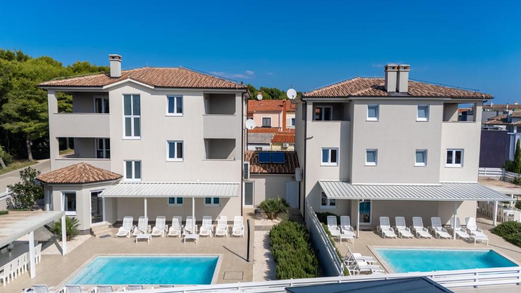 an aerial view of a building with two swimming pools at Villas Marisol in Premantura