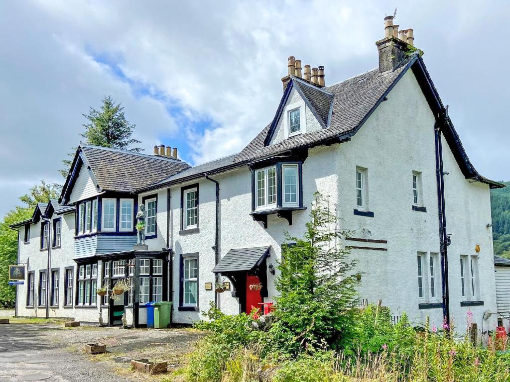 a large white house with a black roof at Hobgoblin Apartment - Uk42205 in Clachan of Glendaruel