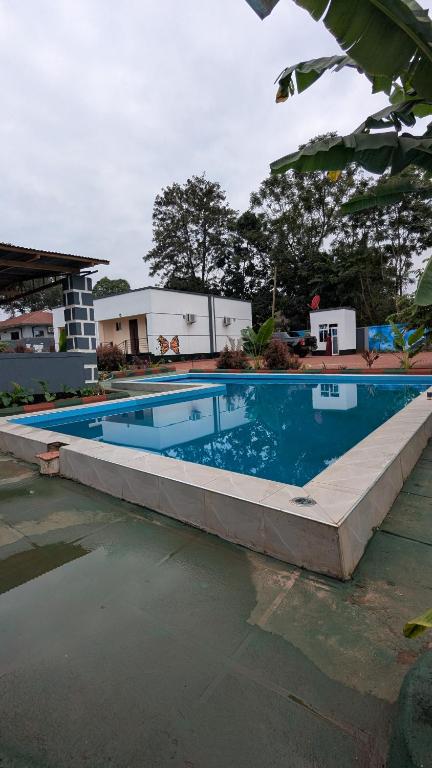 a swimming pool in front of a house at The Serene Maskani in Moshi