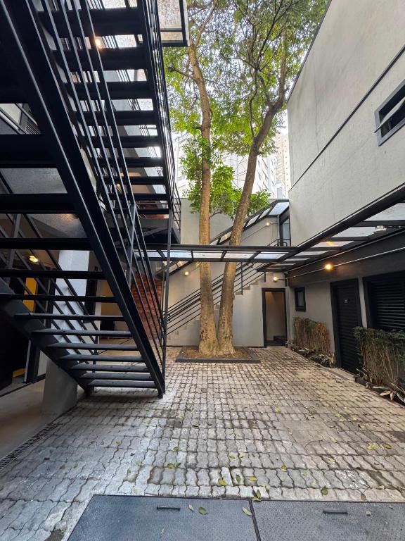 a stairway leading to a building with a tree at Add Hotéis Mascote in São Paulo