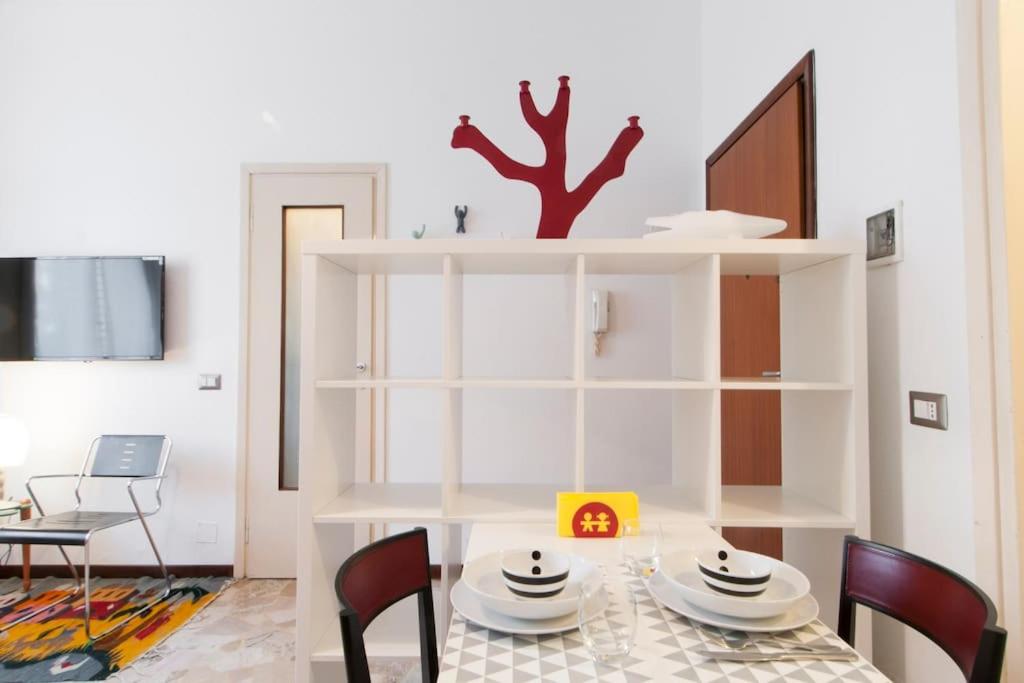 a dining room with a table and chairs at Mauro's Studio in Milan