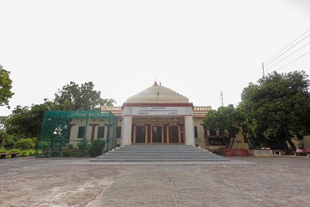a building with a staircase in front of it at Omji Ashram - Maa Anandmayi in Vrindāvan