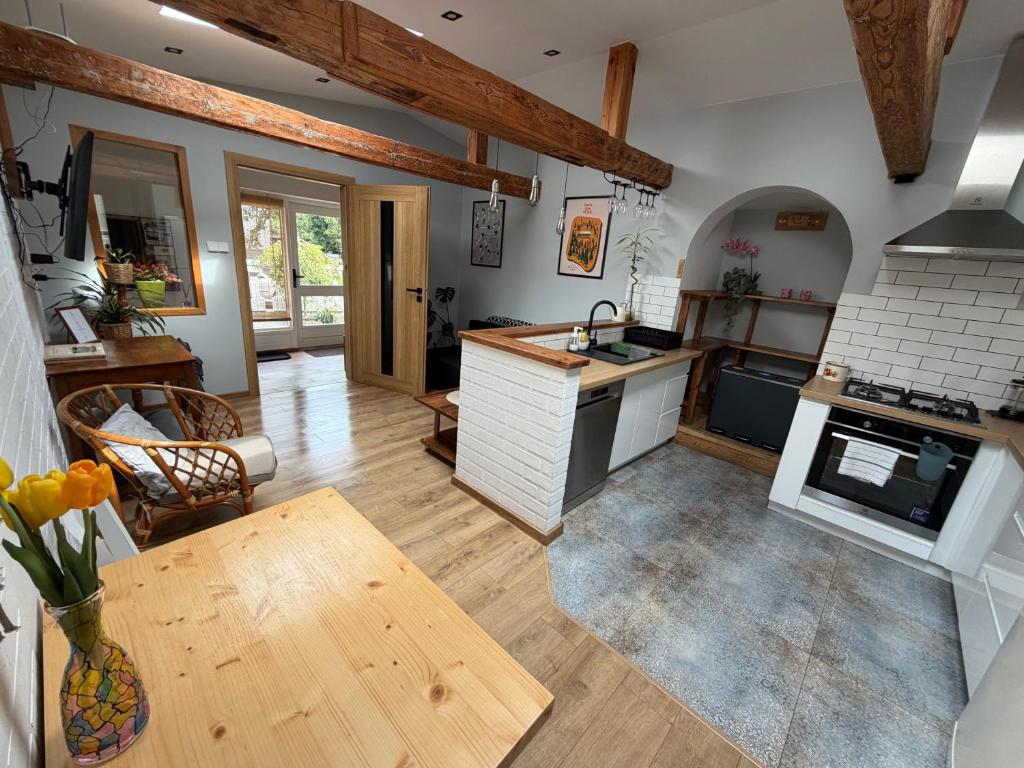 a large kitchen with a table and a stove at SPOKO Chatka in Rypin