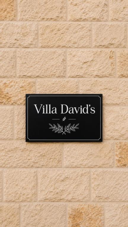 a sign on a wall that reads villa davids at Villa Davids in Koman