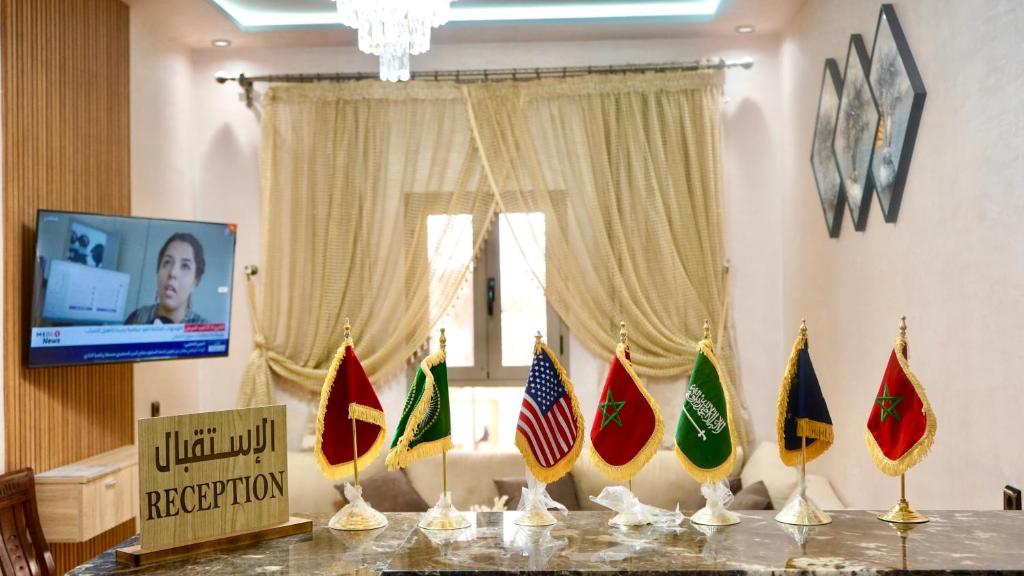 a table with flags on it in a room at Hotel Almou in Ouarzazate