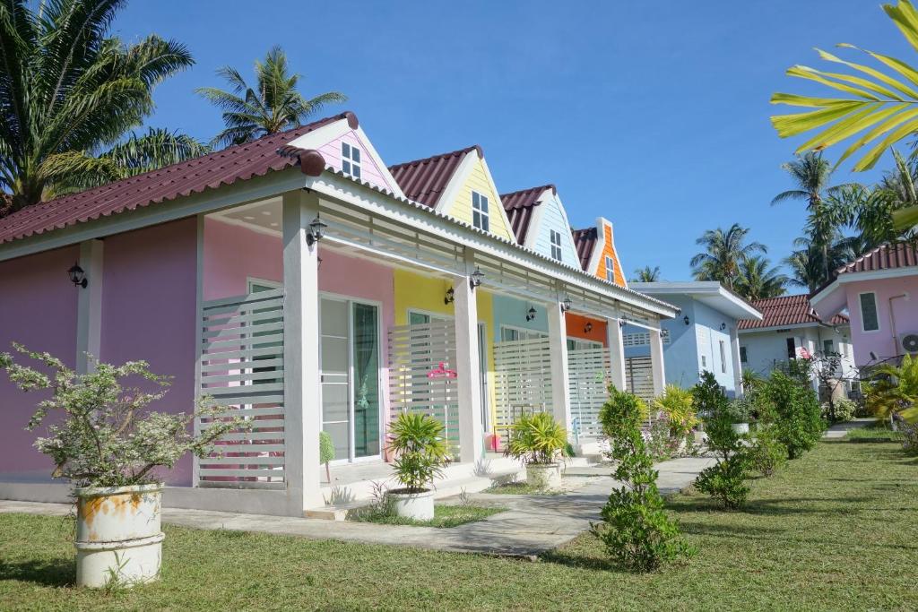 a row of colorful houses on a lawn at Mook Ing Lay in Ko Mook