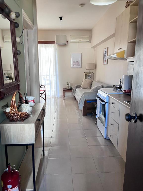 a kitchen and living room with a couch in the background at Almyra Home in Kyparissia