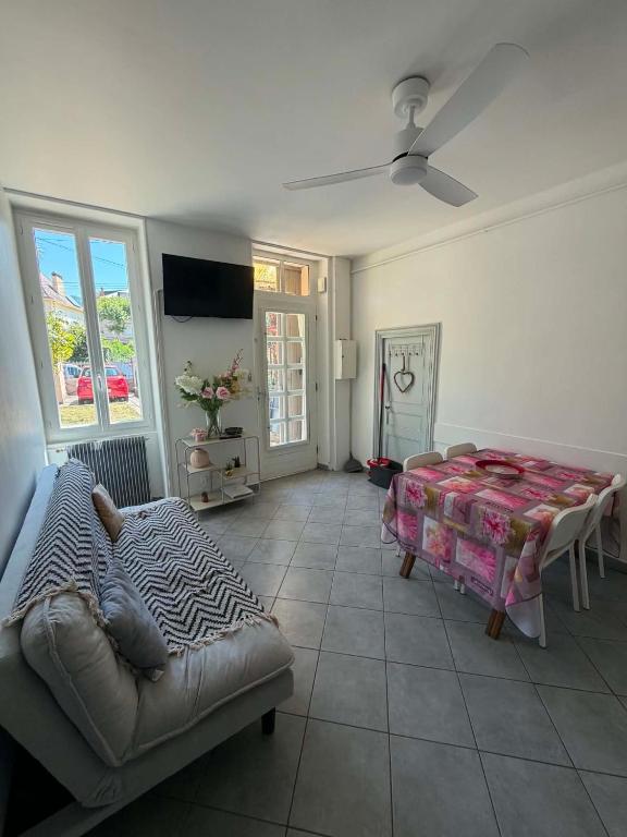 a living room with a bed and a couch at Les Palmiers in Millau