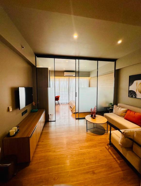 a living room with a couch and a tv at Elite Haven in Raipur