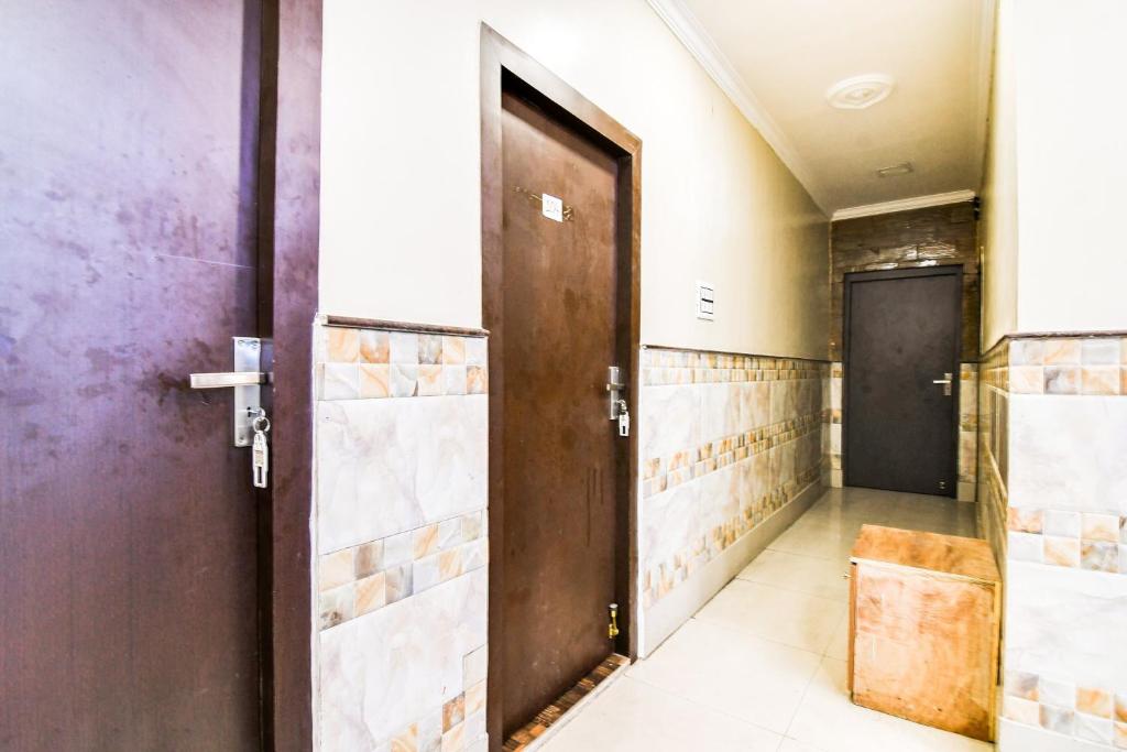 an open door in a hallway with a room with a door at Hotel O Barsana in Pātipukur