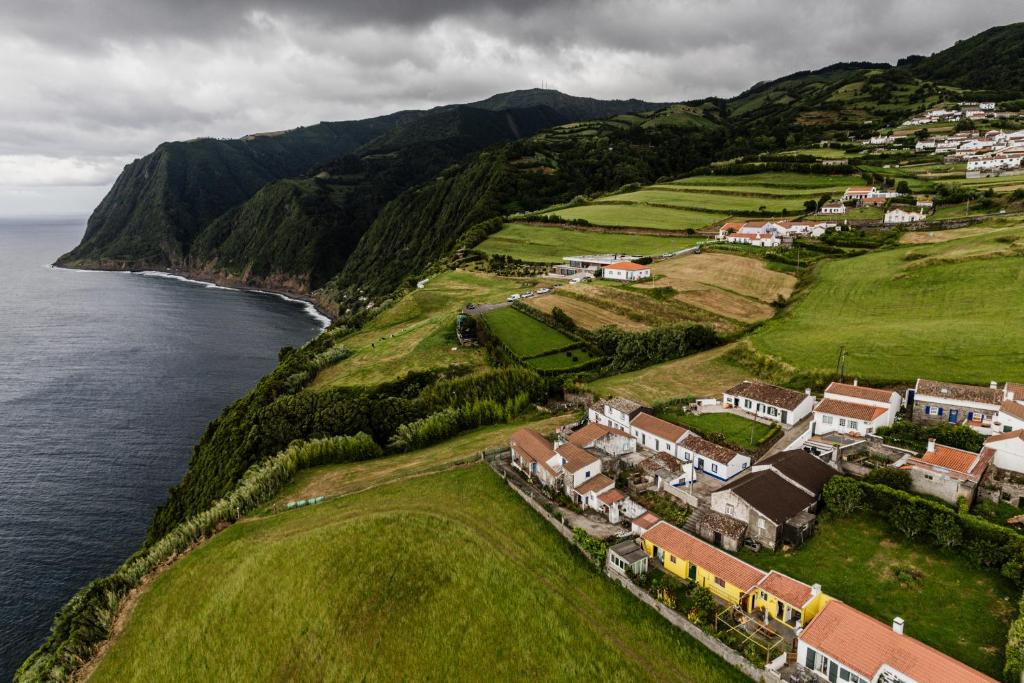 an aerial view of a village next to the ocean at Basaltic House Pedreira in Lomba da Pedreira